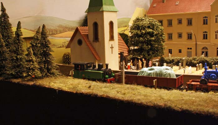 Schmalzberg. An 0-6-0T with a goods train passes the church (with the obligatory wedding).