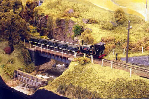 A down slate train crosses the river heading for Trem Yr Aifft.