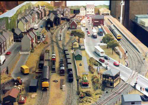 Caeredwyn. This 009 layout was built in 1994 and dismantled in 2015. Caeredwyn Station station boards and track were from the Lothians Light Railway layout.